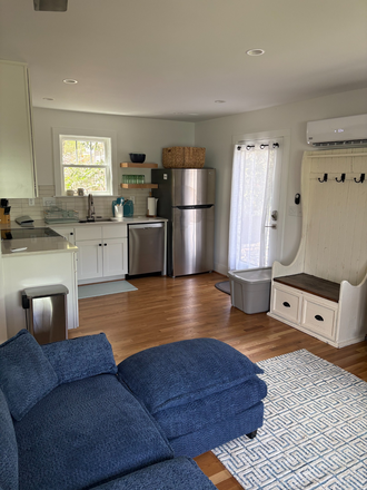 Open kitchen and living room area including dining table - Beautifully Furnished, Quiet Studio Apartment 1 Block from East Campus