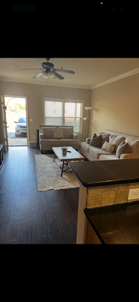 living room couches and chairs - Plainsview Condos