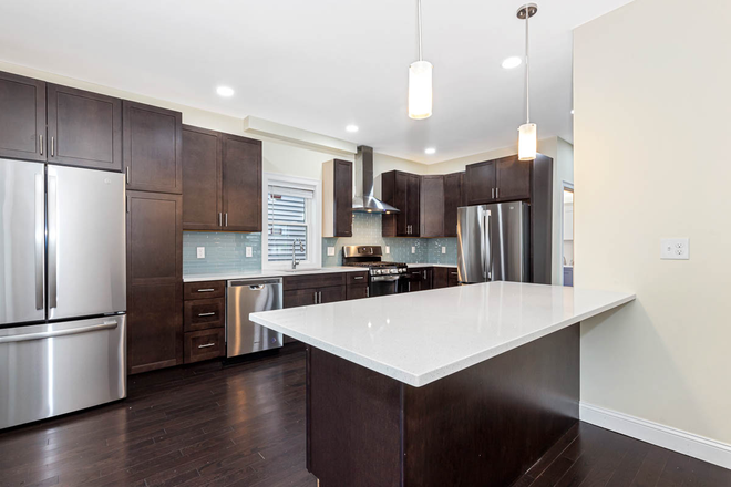 Kitchen - Spacious 7BR/8BA Renovated Home Steps from Tufts & Green Line