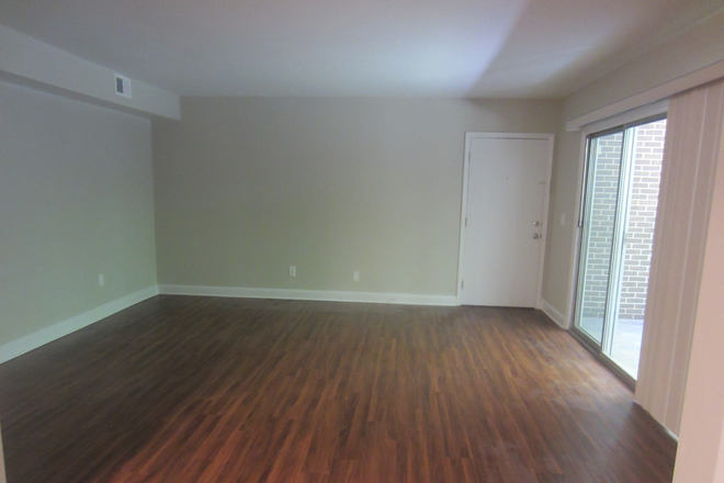 Living room, front door, and patio door - 1 BR, 1BA Condo, walking distance to Emory & CDC (Harwood Condominiums)