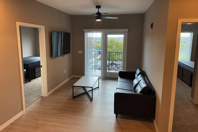 Living room + view of bedroom - 4UP Apartments