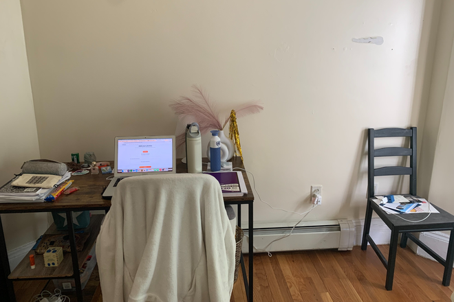 Desk with study chair, additional chair, bin and decoration. - 5 bedroom 2 bathroom apartment