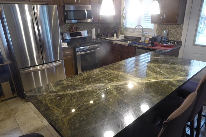 Upstairs kitchen with granite island and stainless steel appliances - Hardwoods & Granite house with 4 Bed and 2 Full bath close to a park & La Salle Academy