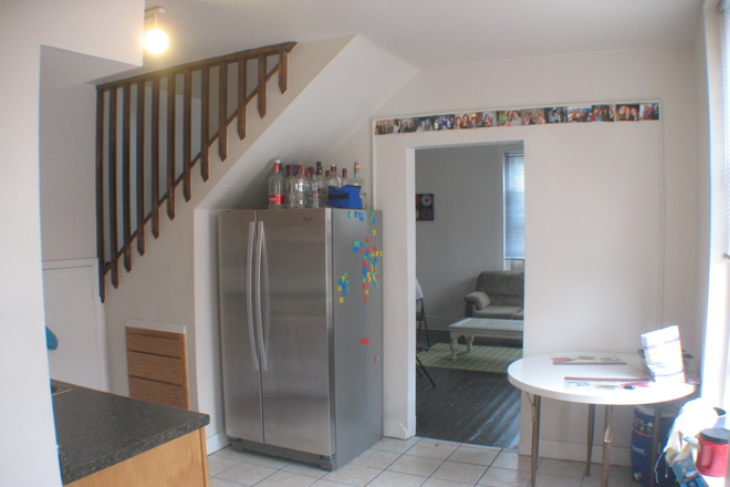 Kitchen with stainless frig and opening to stairs - Rochelle Apts Apt 4