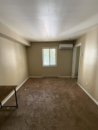 Bedroom with air-conditioner in the background - Launch Apartments