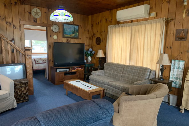 Living room and access to first bedroom - Waterfront Home. Fully Furnished. All Utilities Included. Direct Ocean Access & Beautiful Sunsets.