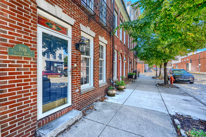 Front door entrance and neighborhood view - Elegant three-level townhome steps from Harbor East, and Baltimore's best dining and nightlife.