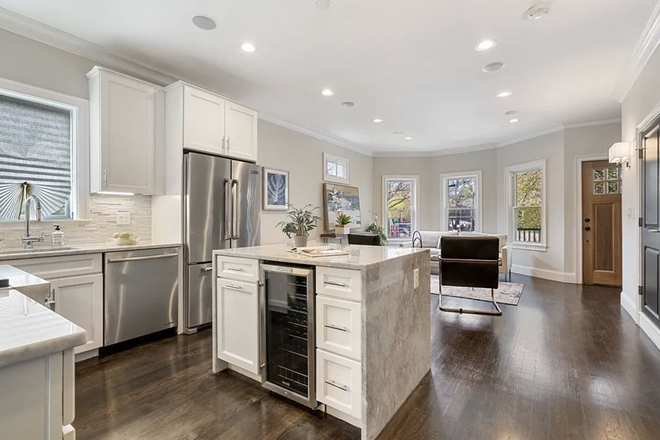 Main living level with kitchen and living area - Beautiful 3BR/2BA near Davis Sq & Magoun Green Line - easy access to Harvard, Tufts