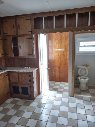 Kitchen with half-bathroom and door leading to the backyard - 3 Bed, 1.5 Bath near Boston Medical Center - Brighton