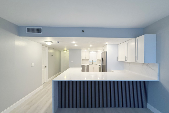Another angle of kitchen and front door hallway with master bedroom door - Remodeled Corner 2BR/2BA Near NSU – Only $1,000 Deposit!