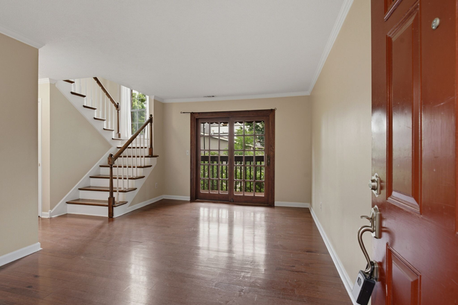 living room with sliding door to covered balcony - Townhouse in Prime Location