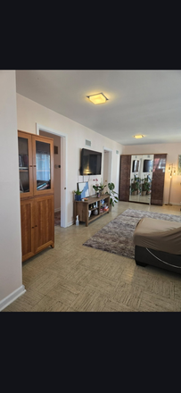 Living room - 2-Bedroom Apartment for Rent – Available July 1 1,100 sq ft, furnished living/dining room, 50-inch T