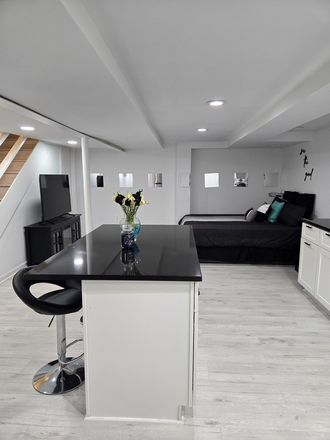 Kitchen Island with plenty of storage - Fully furnished newly remodeled studio apartment 7 minutes from campus