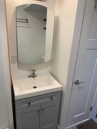 Private bathroom with sink, commode, shower and tub. - Complete Furnished Basement Apartment