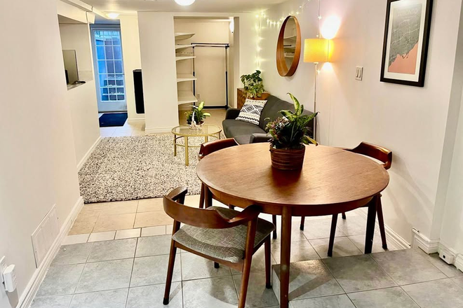 Spacious living and dining area with view to outisde - Spacious 1 Bedroom Basement Apartment Steps to Campus and Kensington Market