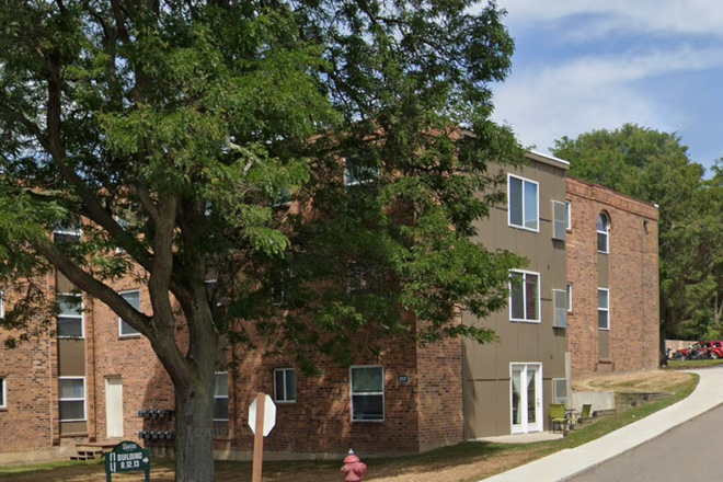 Outside street view. Unit is the ground floor one with the white patio doors. - The Quarters East Lansing, 2bed 1bath Apartments