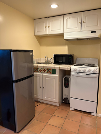 kitchen with a new stove - Studio, built-in shelves, private bathroom, secured entry, close to N. B. Bart Station