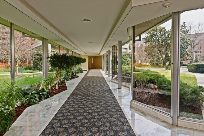 Walkway from Lobby to East Wing - AVAILABLE IMMEDIATELY! Large 3-BR/2-BA Condo with Balcony and Pool Near AU! $4500/MO Incl. Utils!