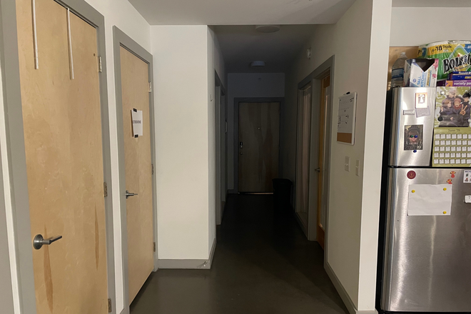Entranceway and hallway, Front Door at end of hall, Available Bedroom w/o ensuite First door on Right, bathroom door to left with paper sign - The Square Apartments