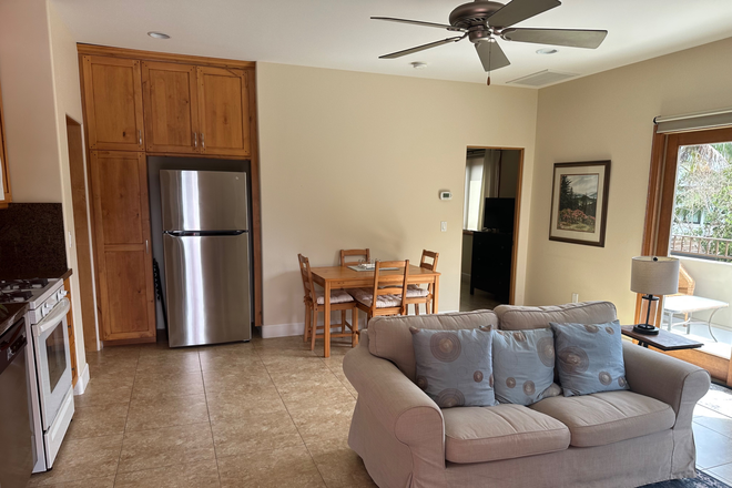 Living room, dining area, and sliding door to balconey - Quiet Cardiff Apt.