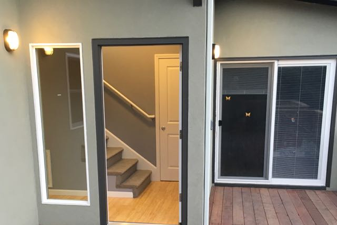 front door from shared deck - Fully furnished, large, 1bdrm in-law unit behind family home. High walkability and biking rating.