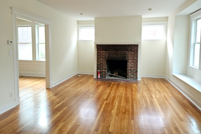 Living room w decorative fireplace - Large, sunny three bedroom first floor apartment w great public transit