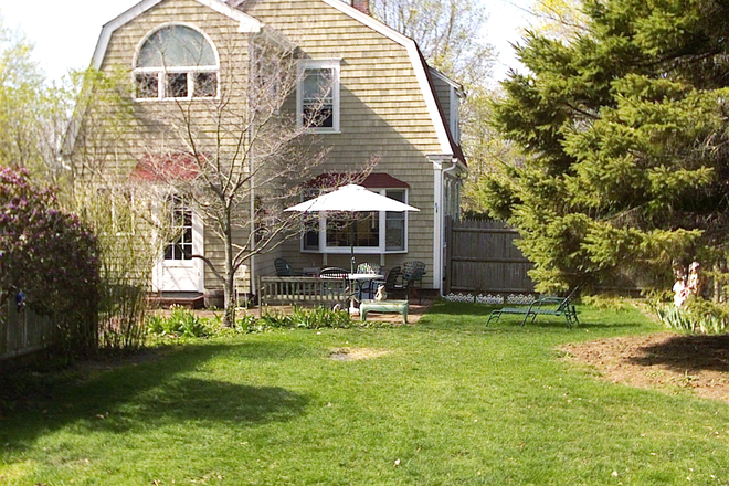 back patio - 3-BR cottage in Wickford Village, No. Kingstown. Walk to beach, shopping and bus.