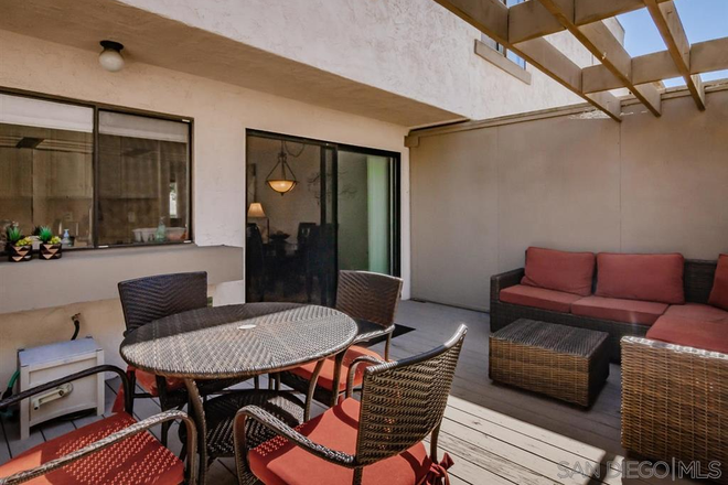Back outdoor area off of living room - Fully furnished, utilities included, 2 bd, 2.5 ba condo with 2-car garage close to campus