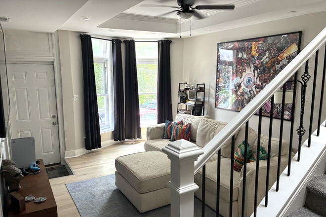 Living Room - Brand-new Lovesac Couch, Bookshelf, 65" Smart TV (Apple AirPlay + streaming services ready) - Furnished! House In Hampden, Baltimore - The Greatest Place to Live!