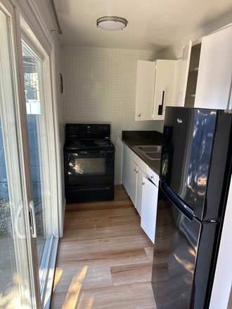 Kitchen - Furnished 1-Bedroom 1-Bath Apartment with FREE parking and patio/deck in Prime Location