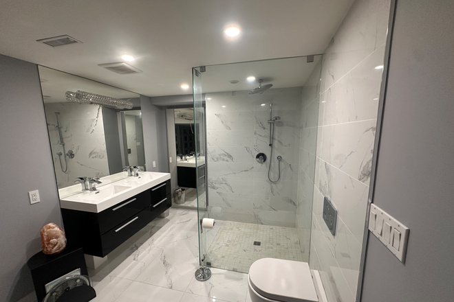 Washroom wall hung toilet glass shower double sink vanity - Fully Furnished Lorne Park Studio basement utilities included for single occupancy only! $1,995/mth