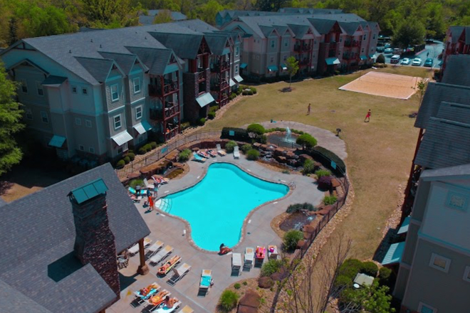 Pool, green space, and volleyball court in the middle of the apartment complex - Crawford Falls, Apartment within walking distance to campus