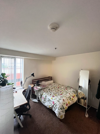 Furnished bedroom with queen bed, large desk, monitor, and closet - Summer Sublet: Furnished 1BR/1BA in 2BR Harvard Housing – All Utilities Incl, June–Aug