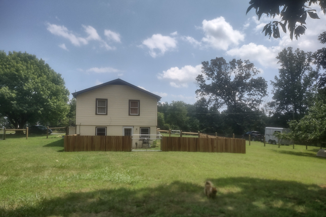 Picture of house. Studio apartment is at ground level, has private gate entrance to private new poplar fenced in yard (as seen in pic). - Dog friendly studio apartment