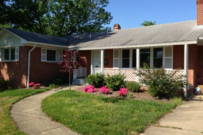 Front of house shows the front porch and the entrance to the carport on the right. - Bedroom in big comfortable house available close to UMD campus