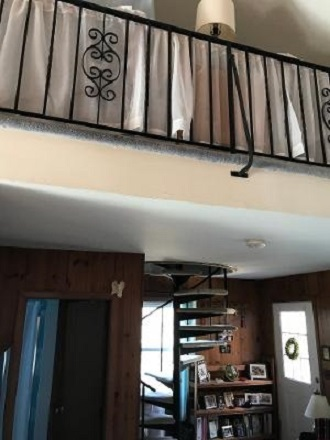 Living room with spiral staircase to loft bedroom - Ocean Front/Private Beach Apartments