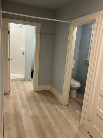 Hallway view of bathroom shower,separate toilet area - 2 bedroom 1 bath MacArthur Bart, Kaiser,A/C Bus lines, parking, washer/dryer in unit