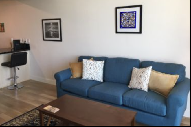 Living Room; has large wall-mounted TV - Furnished 1BR/1BA in Brickell Apartments