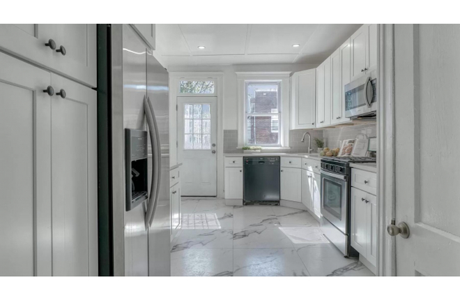 Kitchen View from Entryway - Charming Maryland-Themed Room at The Baltimore Townhome