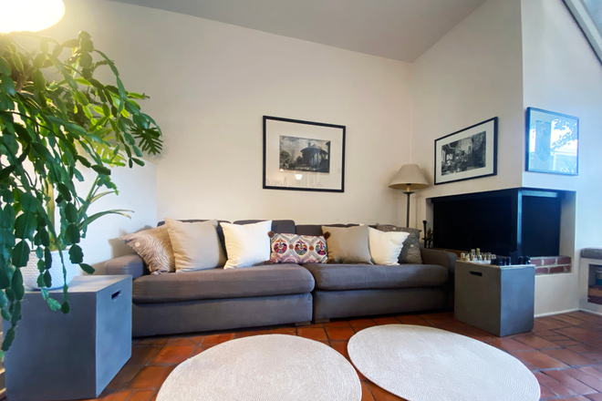 Living room with working fireplace - Wonderful Furnished Rowhouse in Heart of Capitol Hill
