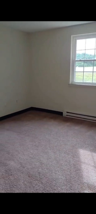 Old photo of bedroom, currently, it has bed, table, side table, chair - Lantern Court Apartments