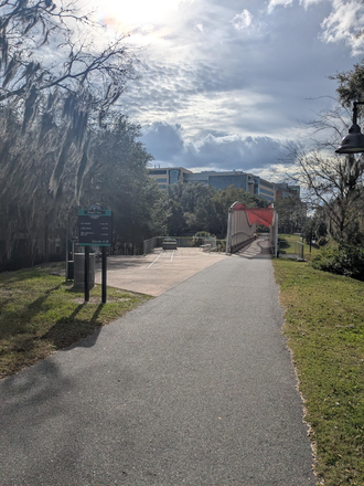 SIGN SHOWING 0.25 MI WALK OVER PEDESTRIAN BRIDGE TO BOTH SHANDS/DENTAL SCHOOL FROM OUT BACK APT - AMAZING PRIVATE BED/BATH IN 3/3 0.25 MI FROM SHANDS Apartments