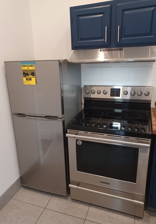 New Oven, Vented exhaust hood and refrigerator - Grove Townhouse Apartment