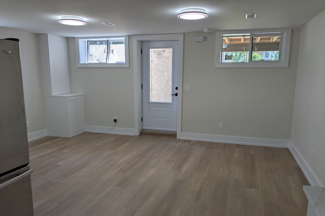 Front door view from kitchen, including living space. - Brand new, legal basement apartment with private entrance and ensuite laundry