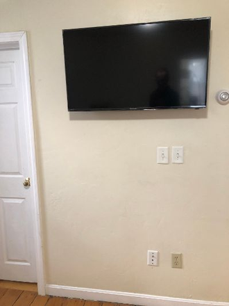 Smart TV in living room - Beautiful, renovated 2BR townhouse style unit with office, near T, with laundry in building