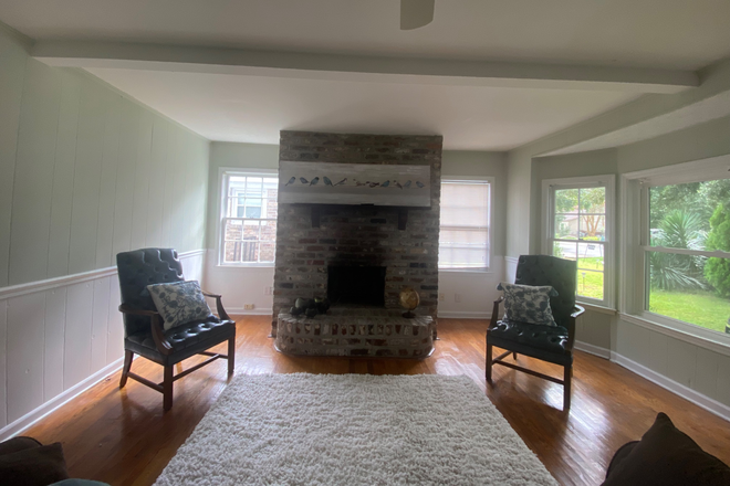 Large living room with wood fireplace - Furnished James Island home including utilities - minutes to campus and to the beach