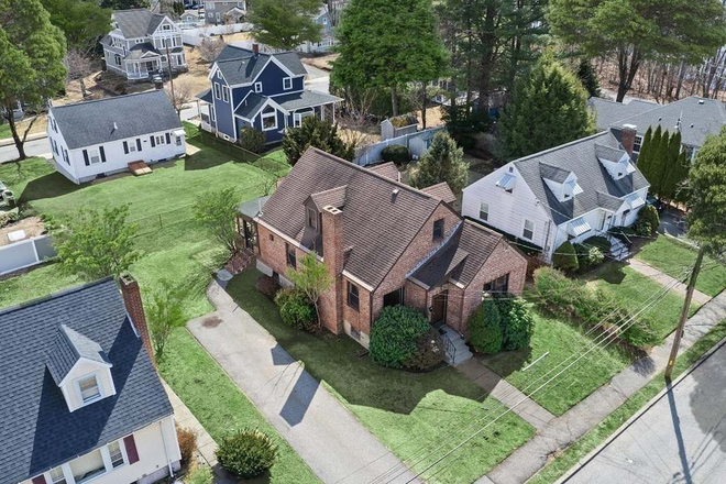 Photo of the house from the air, driveway and backyard in view. - Single Family Home near campus, 6 bed 3 bath modern appliances & washer/dryer included.
