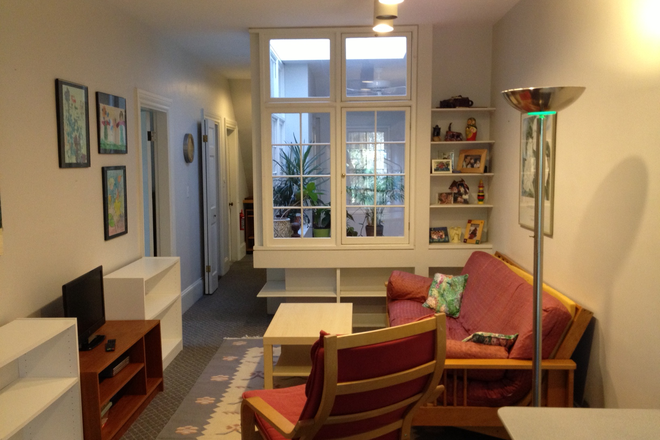Living Area 10x14 with central skylight - Daylight-filled, Furnished, One Bedroom Suite, One Block to T and Stores, All utilities Included