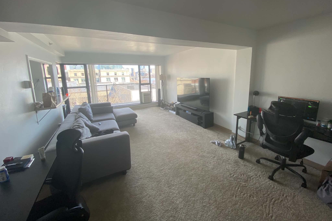 Spacious furnished living room with sectional sofa and four workstations - Furnished 2BR at 100 Memorial – Balcony & Charles River Views Apartments