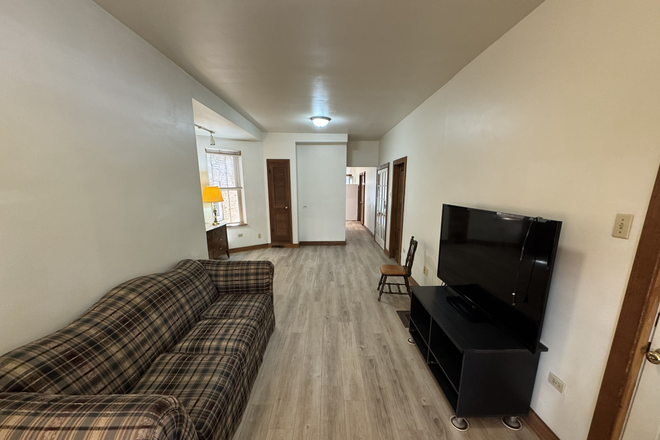 Living Room foreground, dining room in the back ground - Between UIC East & West Campuses Apartments